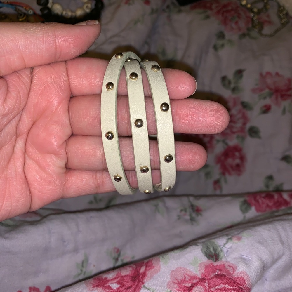 Cream leather wrapped bracelet with gold studs.